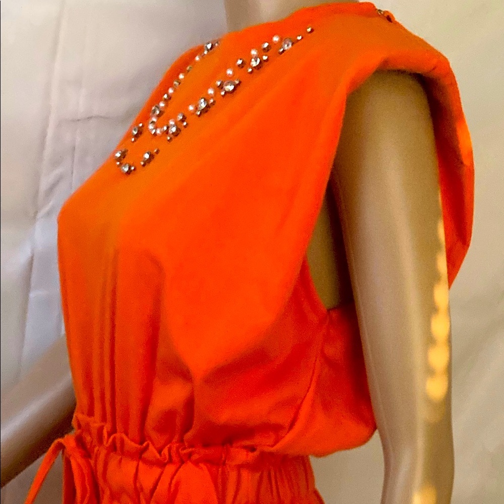 Orange romper with rime-stones size small.Never worn